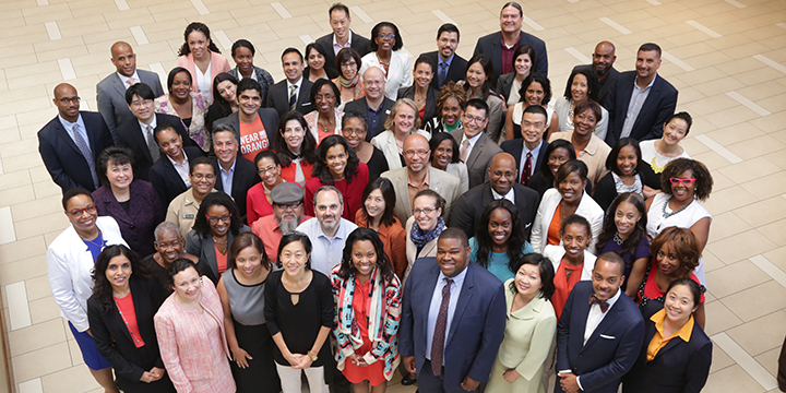 A group of oral health fellow look up at the camera.