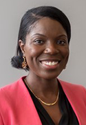 Azeesat Babajide is wearing a black blouse and pink blazer. 
