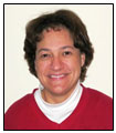 Camilia R. Martin is wearing a white turtleneck underneath a red sweater.
