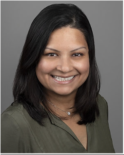 Megha Gupta has medium-length black hair. She is wearing a green blouse.