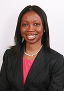 Oreofe O. Odejide has long black hair and is wearing a pink blouse with a black blazer.