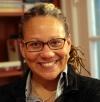 Kathryn T. Hall is standing in front of a bookshelf.