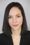 Mélissa Léger-Abraham has medium length straight black hair. She is wearing a black blouse.