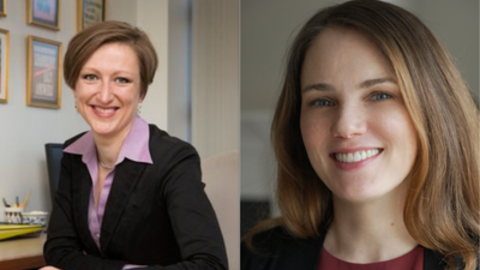 Julia Minson (left) has short brown hair is sitting behind a desk. Heather Sulejman (right) has long brown hair is wearing a maroon blouse.