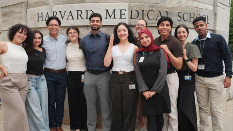 VRIP students stand in a line in front of the HMS sign on the Quad.