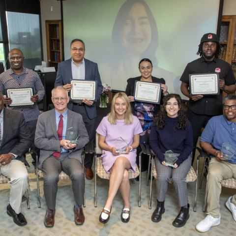 The Dean's Community Service Award recipients and organization reps sit in the Minot Room in Countway Library.