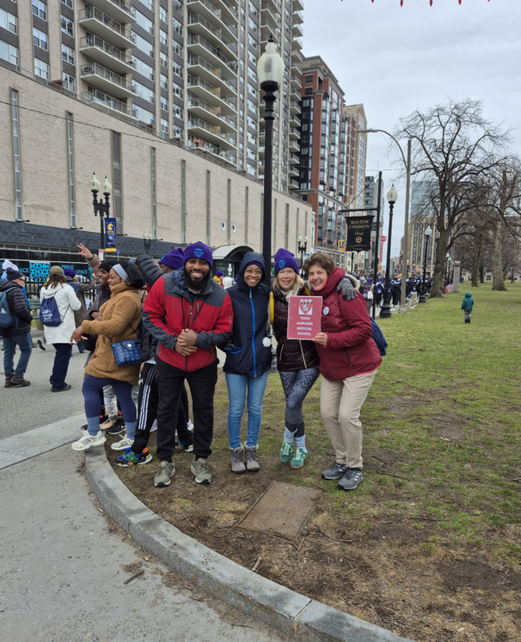 The Harvard Longwood team stands in Boston Common, huddled together in the cold.
