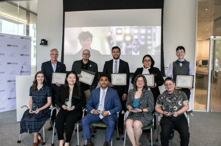 Award recipients and partner organization representatives sit and stand in a Countway Library classroom.