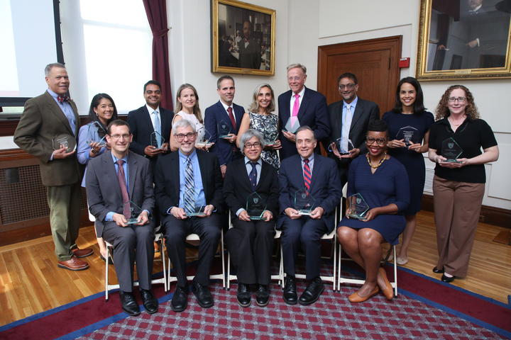 The recipients of the 2026 Excellence in Mentoring Awards pose with their awards in the Waterhouse Room.
