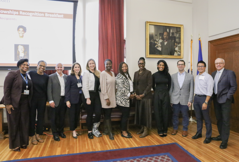 Fellows stand in a line alongside their mentors, Joan Reede, and George Daley.