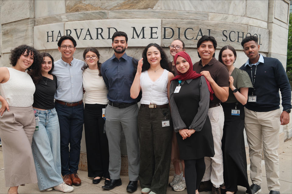 VRIP students stand in a line in front of the HMS sign on the Quad.