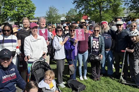 The 2025 Longwood Campus team stands amongst the crowd of people for the Mother's Day walk. 