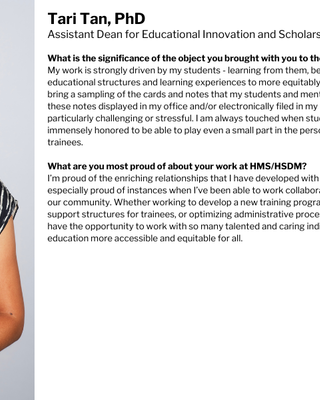 Tari Tan is wearing a black and white printed blouse. She is holding a bunch of cards and notes from students.