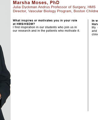 Marsha Moses is wearing a black blazer and multicolor floral blouse. She is holding her white BCH coat.