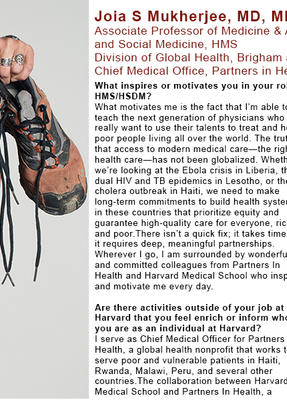 Joia Mukherjee is holding up a pair of roughed up sneakers covered in dirt.