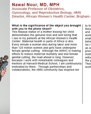 Nawal Nour is wearing a black and white patterned dress and holding a Maasai statue of a mother kissing her child