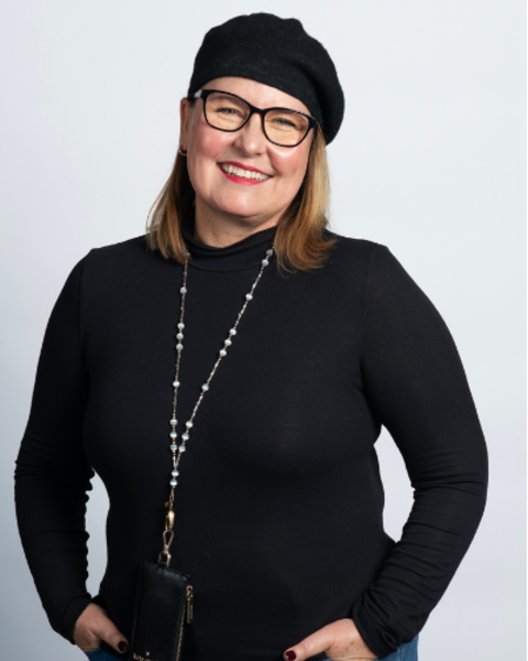 MJ Grein is wearing a black turtleneck shirt, blue jeans, and a black beret. She also had a beaded Kate Spade lanyard on.
