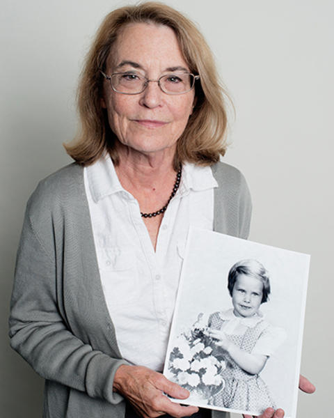 Xandra Breakefield is holding a black-and-white photo of her younger sister, who is pictured with a basket of flowers.
