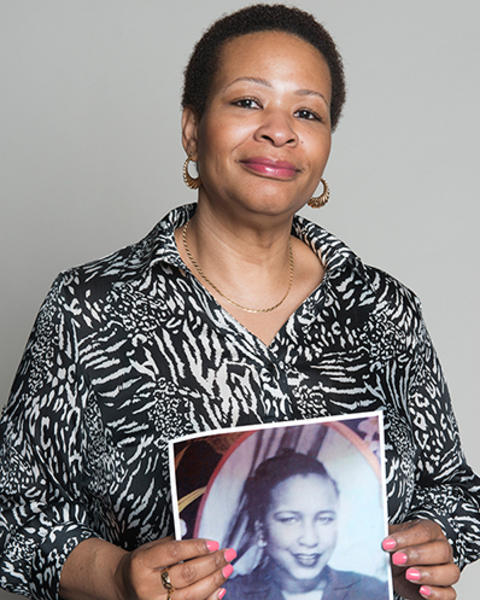Lillian Johnson is holding a photo of her mother.