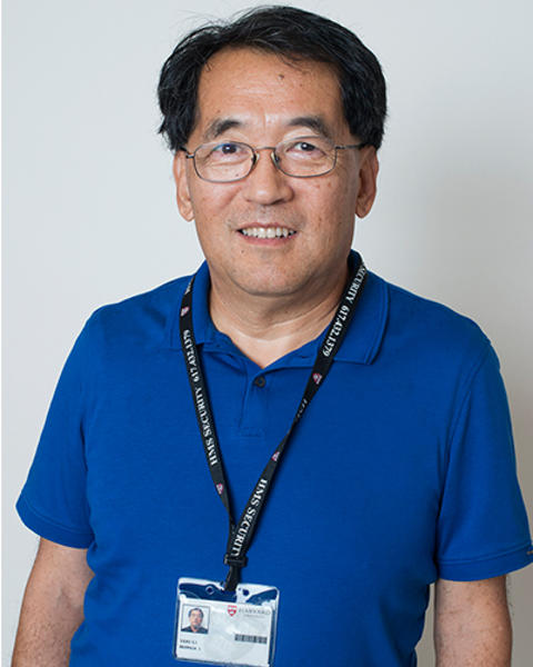 Yefu Li is wearing a blue polo and and a black lanyard with his HUID on it.