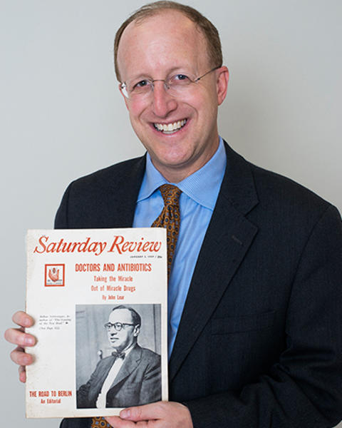 Scott Podolsky is holding the 1959 issue of the Saturday Review.
