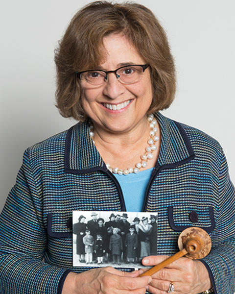 Susan Pories is holding a photo of her father and his family and a wooden stethoscope from her great aunt Johanna.