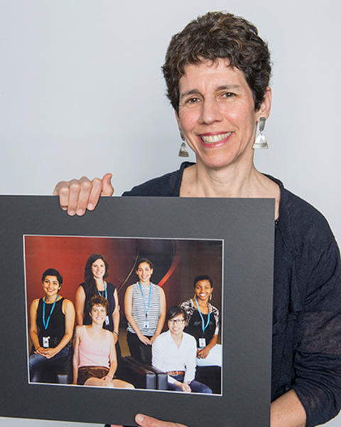 Jennifer Potter is holding photo of six of her mentees.