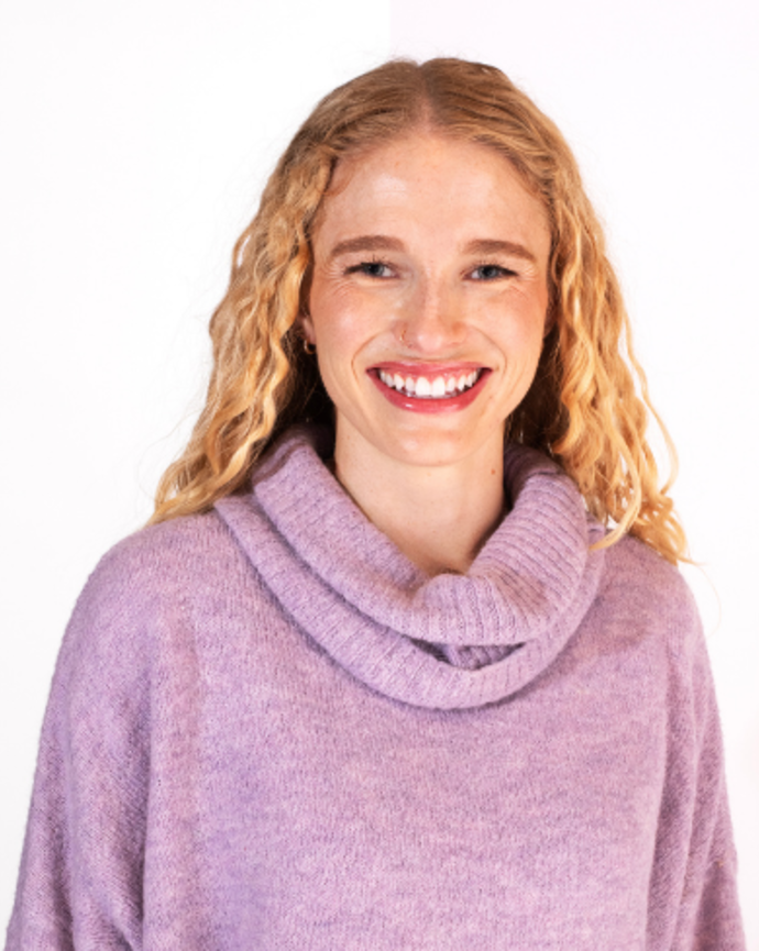 Kelsey Biddle is wearing a lavender cowl-neck sweater.