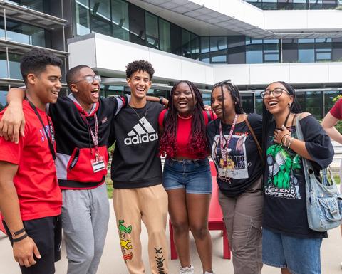 A group of students laugh outside the Science and Engineering Complex in Allston.