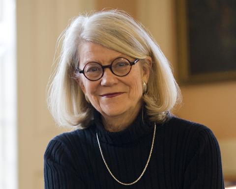 Diana Eck sitting in a chair with her arms crossed. 