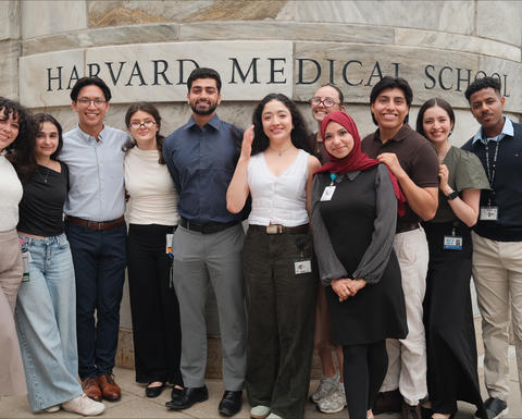 VRIP students stand in a line in front of the HMS sign on the Quad.